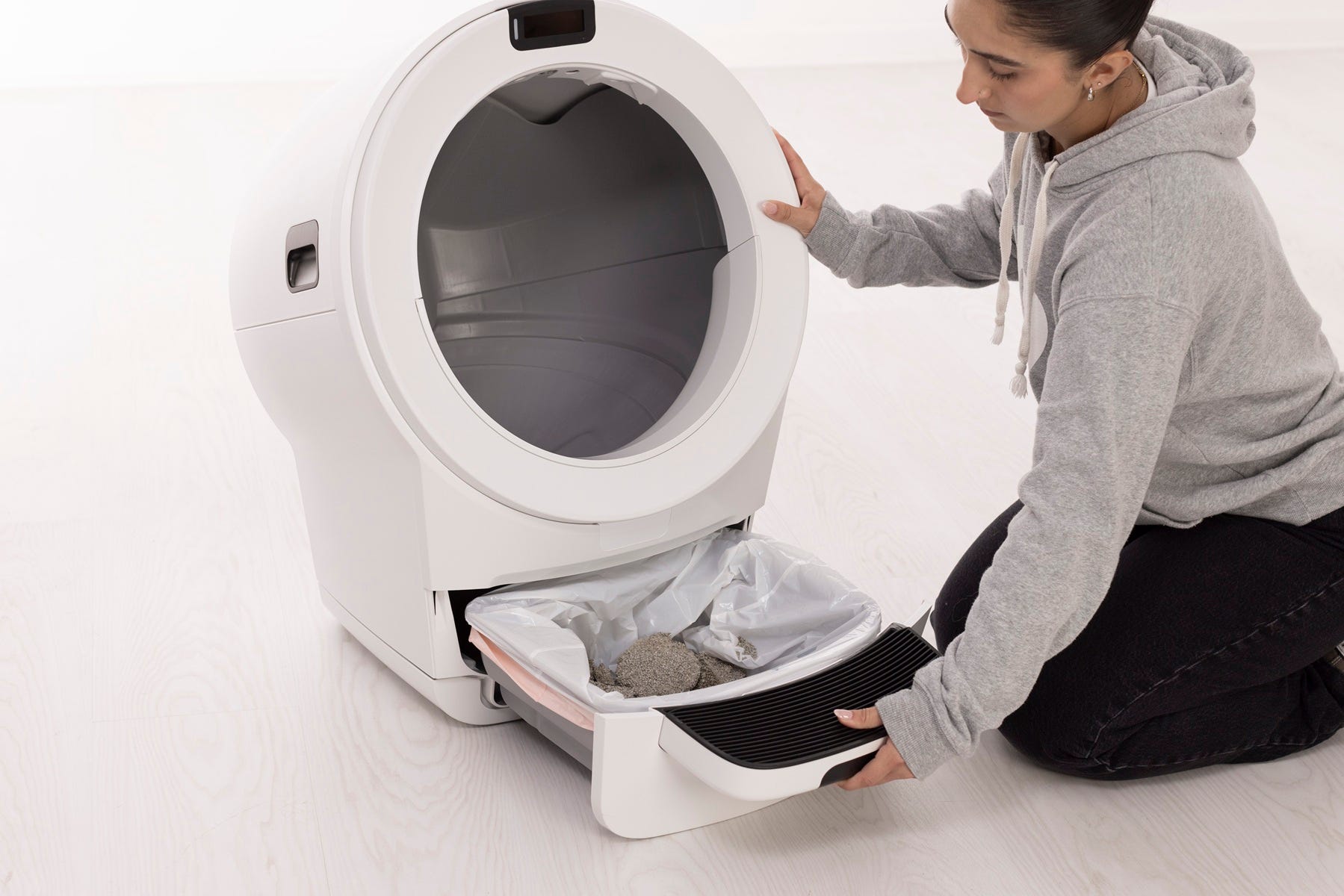 Retirer le tiroir à déchets de l'appareil par l'étape