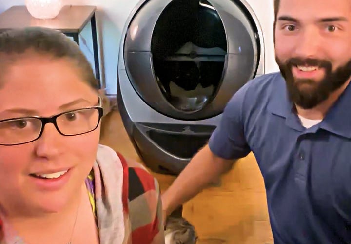 Smiling couple in front of Litter-Robot