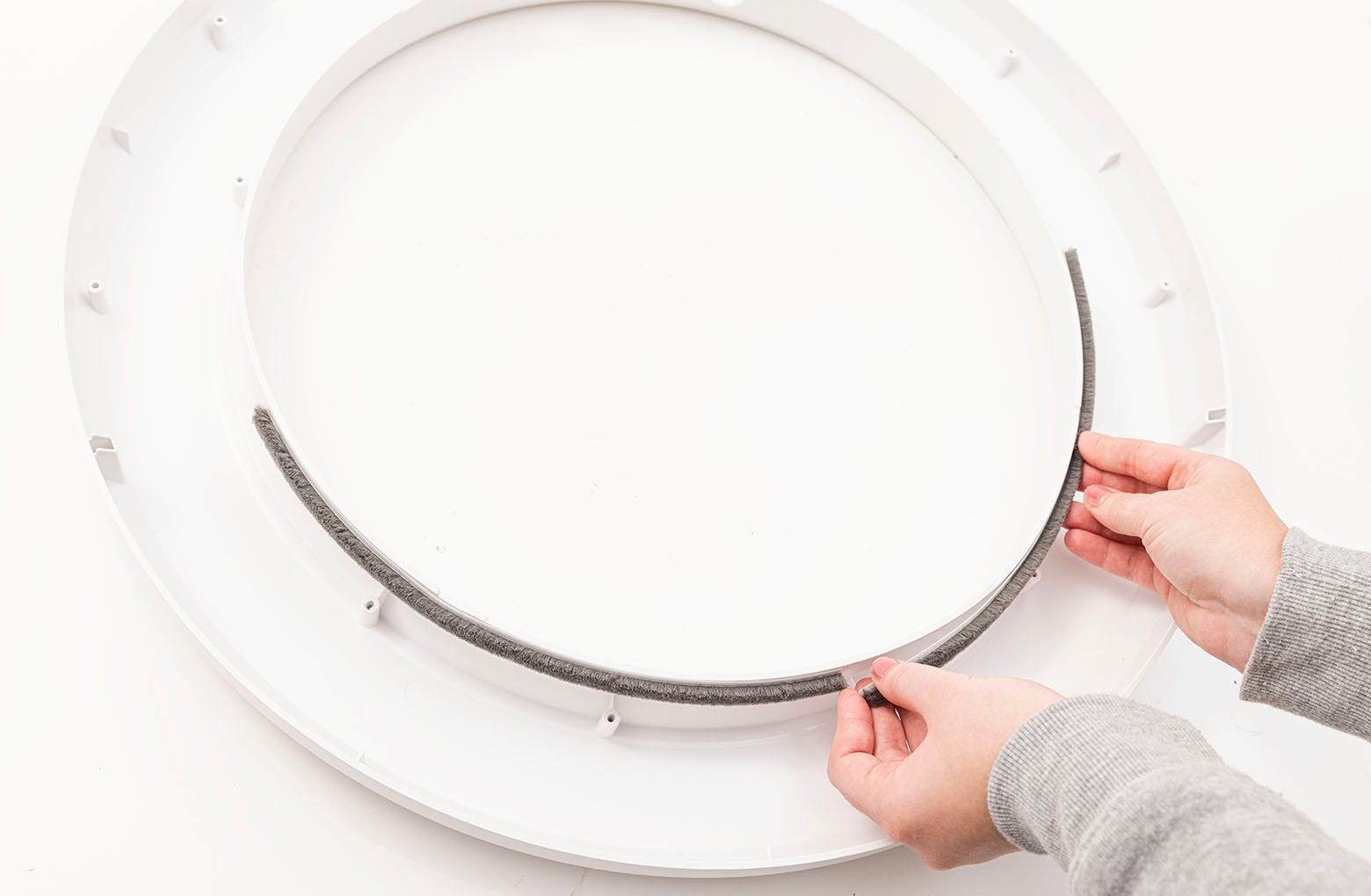 Placing the strip to the left of the bottom center of the bezel