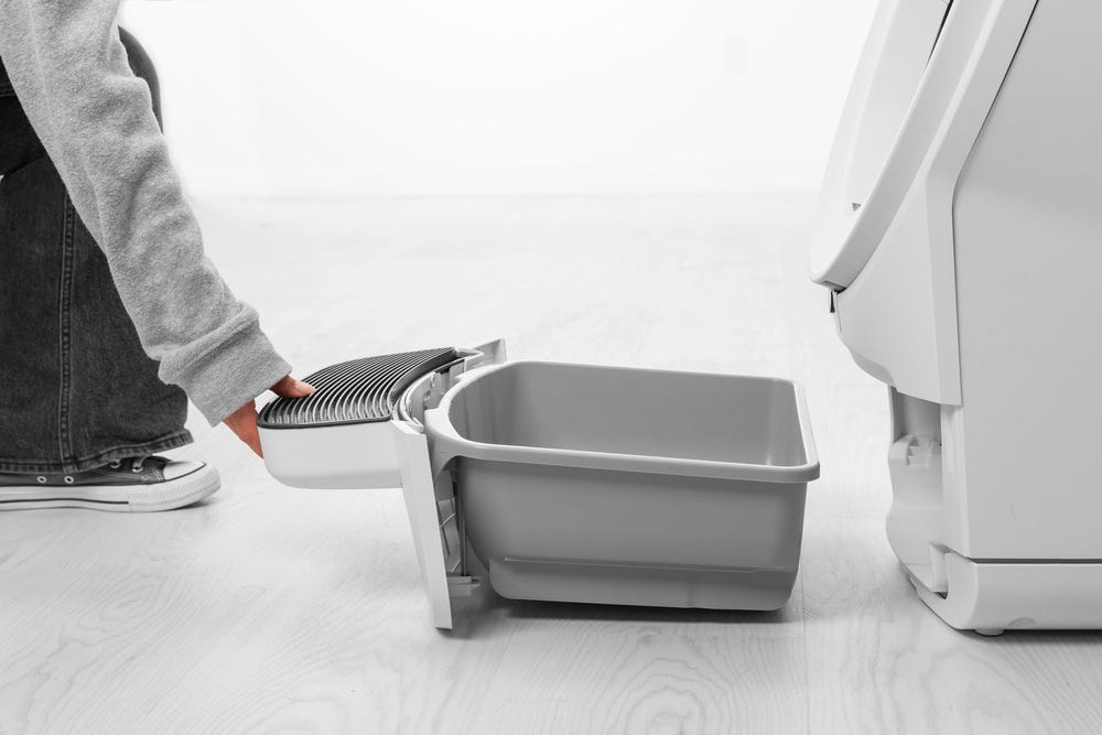 Waste drawer being removed from base