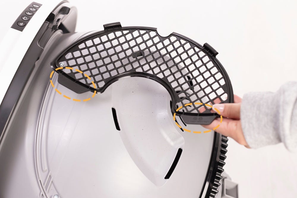 Inserting bottom two tabs of filter cover