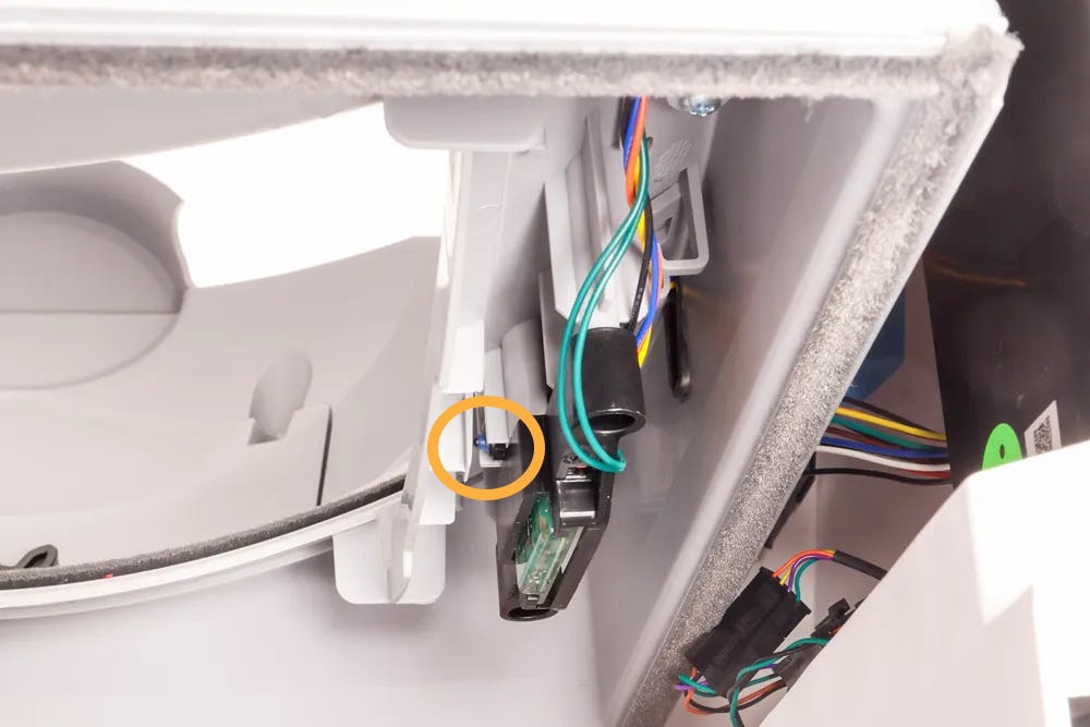 Inside of Litter-Robot EVO base with circle around pinch bar button