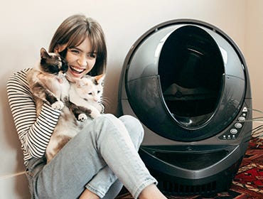 Smiling girl with kittens and Litter-Robot