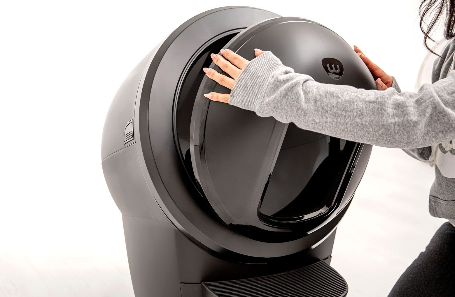 Pulling the top of the Litter-Robot shield away from the bezel