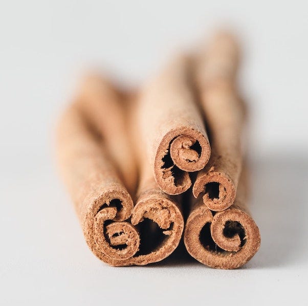 cinnamon sticks stacked on a white blurred background - smells cats hate