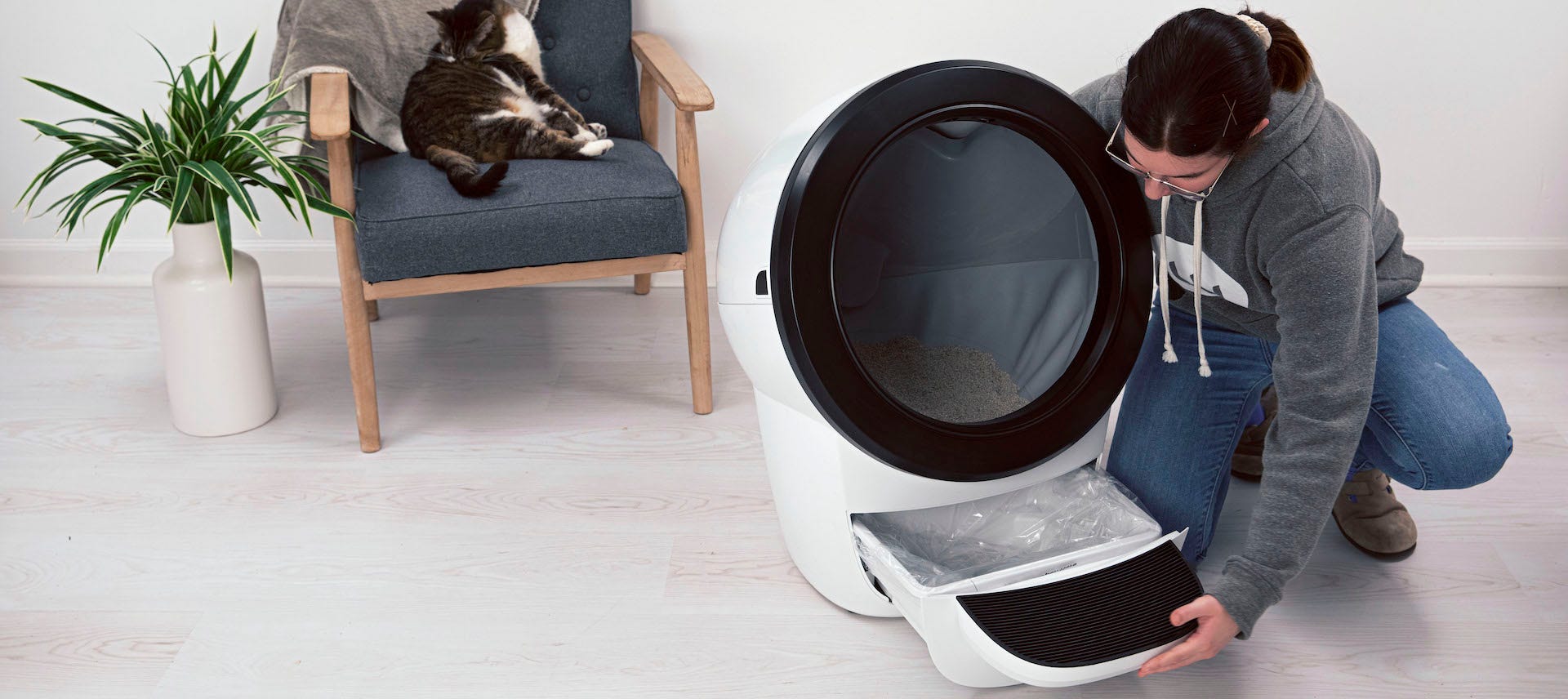 woman and cat with Litter-Robot 4 bag waste drawer liner
