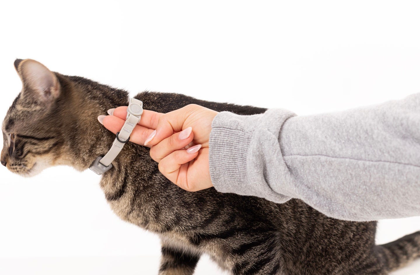 Showing two fingers under collar to demonstrate correct fit