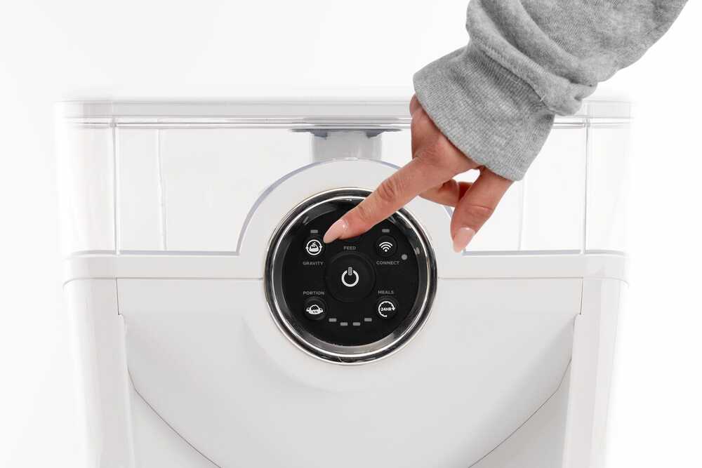 Performing a test dispense by pressing the ‘Feed’ button on the control panel