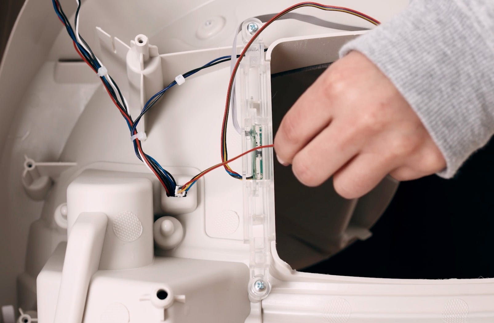 Feeding DFI wires through hole toward control panel side