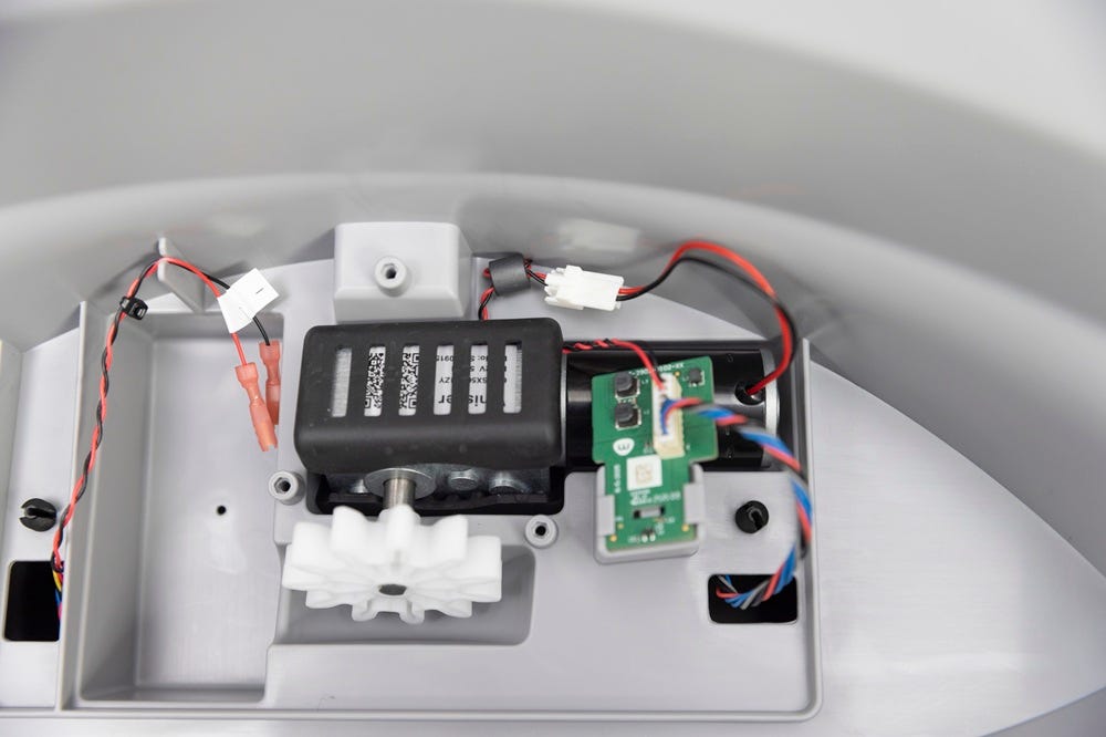 Motor installed in motor cavity with wires in channels