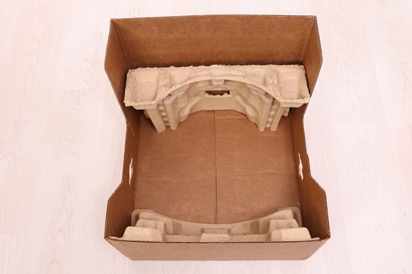 Placing bottom back and bottom front molded pulp inserts in the bottom tray