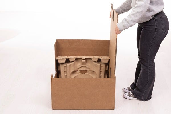 Placing bottom back and bottom front molded pulp inserts in the bottom tray