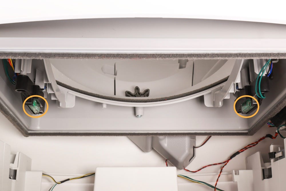 Inisde of lower base with circles around drawer full indicator sensors on either side