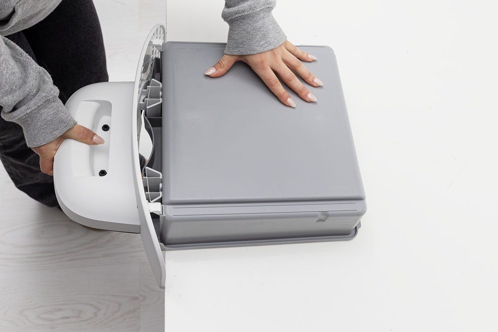 Waste drawer front and drawer body protruding over table edge