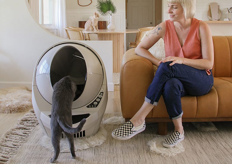 Woman watching cat go into Litter-Robot