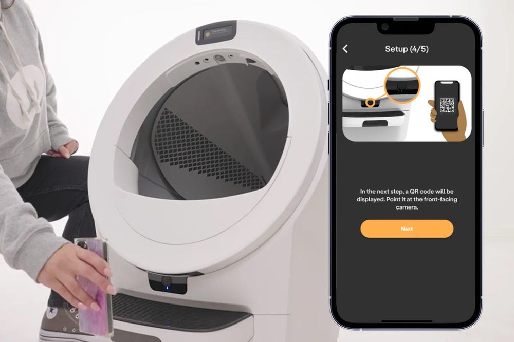 Phone held up to Litter-Robot's front-facing camera to scan QR code displayed on phone.