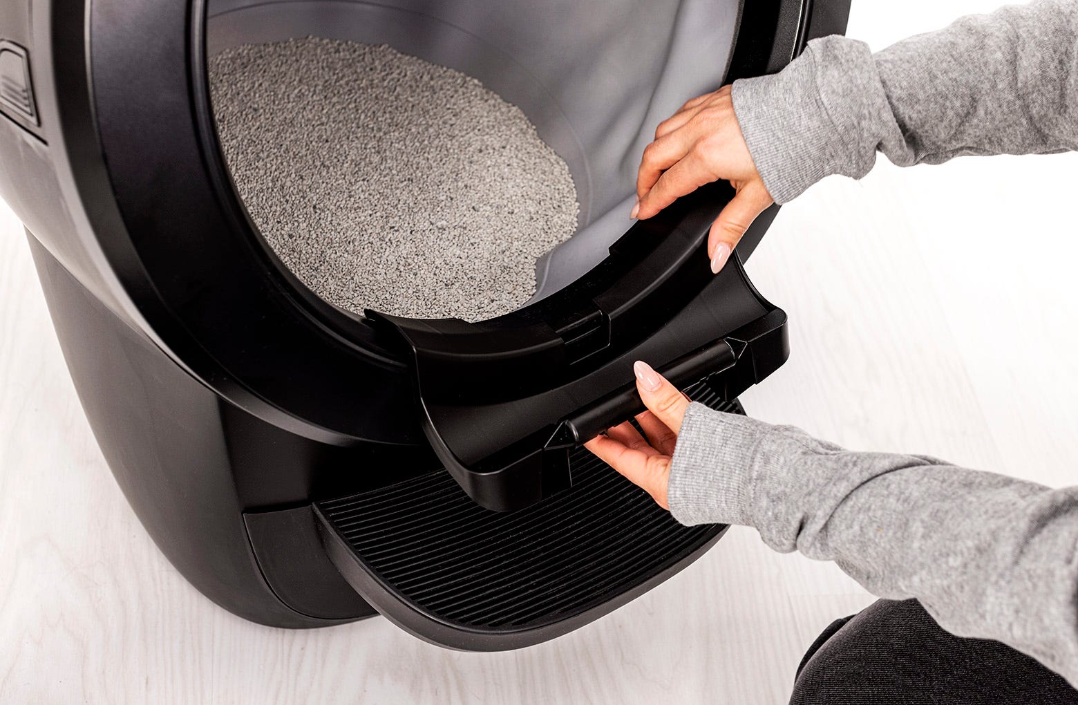 Setting the shield hinge onto the bezel using the notches as a guide to center the hinge